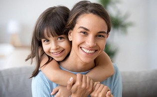 Mom and daughter smiling together