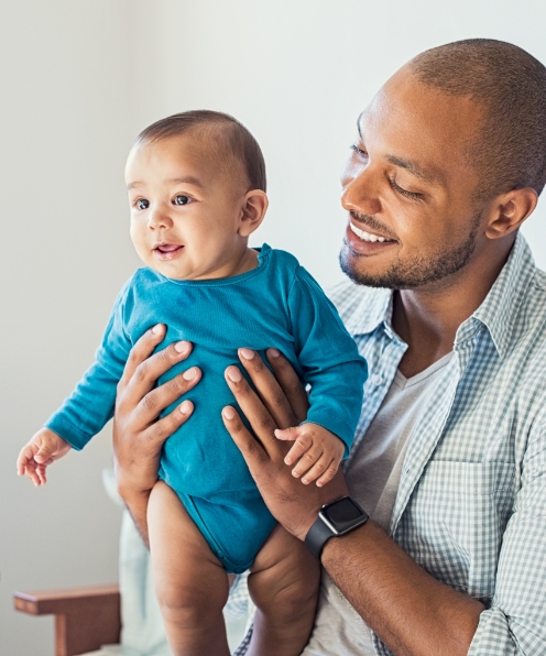 Father holding baby during dentistry for infants visit