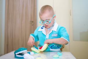 Child with down syndrome plays with dental toys