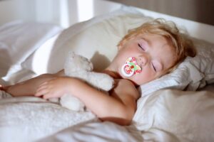 Toddler sleeping with pacifier in mouth